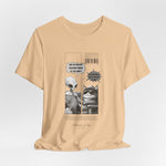 The GRAVITY t-shirt in Sand Dune — 3D mockup of sandy tan tone, printed comic visible, clean backdrop and no human figure.