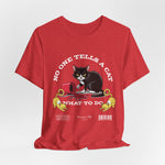The No One Tells a Cat t-shirt in heatherred — ghost mockup showing a soft heathered red tone with no background or model.