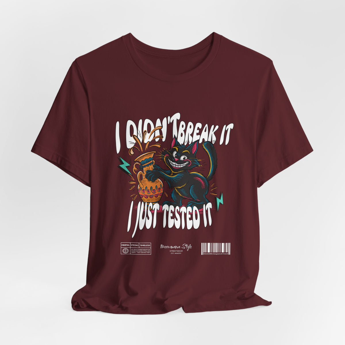 The I Just Tested It t-shirt in maroon — a rich, deep burgundy that gives the rebellious cat a bold, moody backdrop.