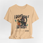 The I Just Tested It t-shirt in sand dune — an earthy beige that grounds the cat’s chaos with subtle warmth.