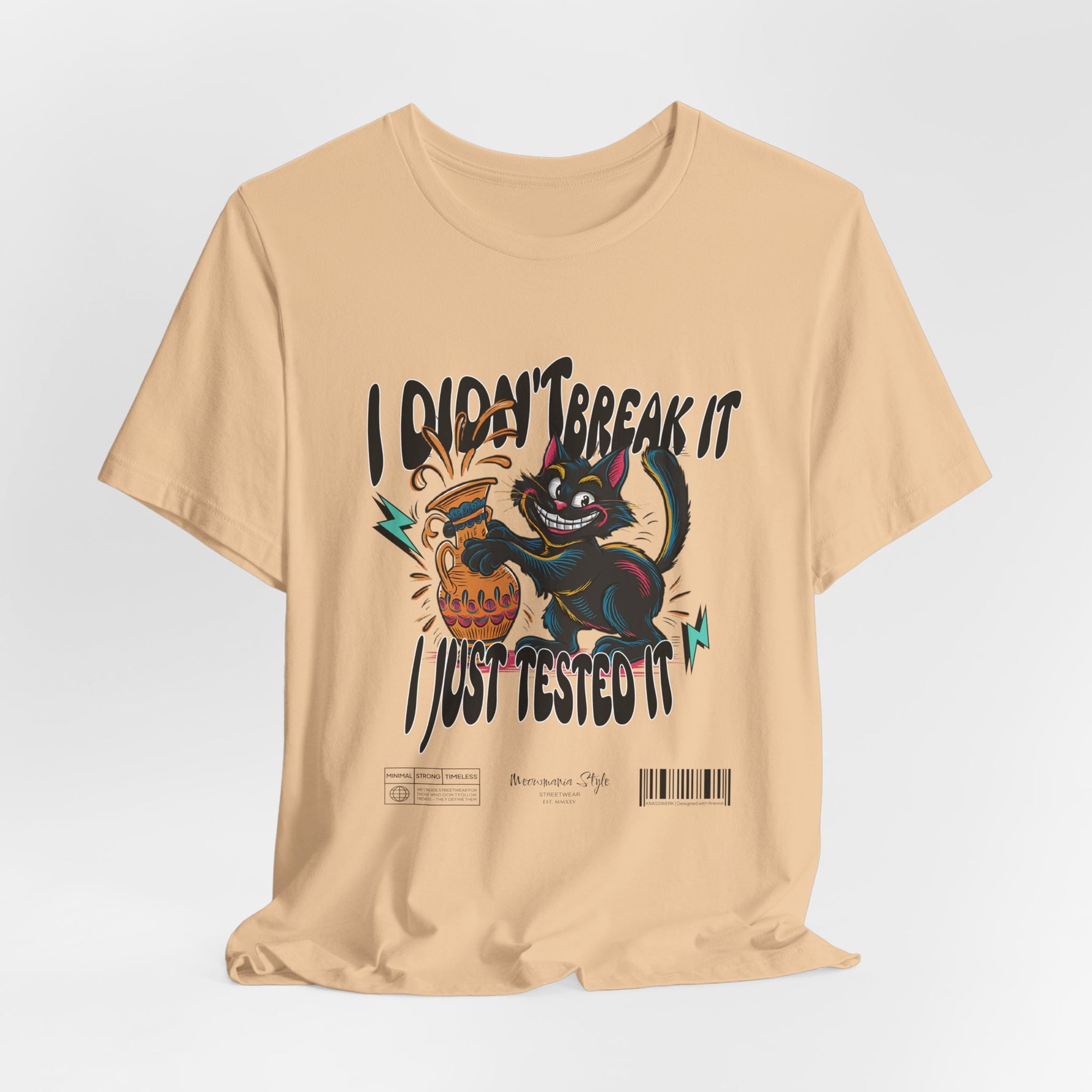 The I Just Tested It t-shirt in sand dune — an earthy beige that grounds the cat’s chaos with subtle warmth.