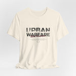 The URBAN WARFARE t-shirt in Natural — the quietest ones leave the deepest cracks.