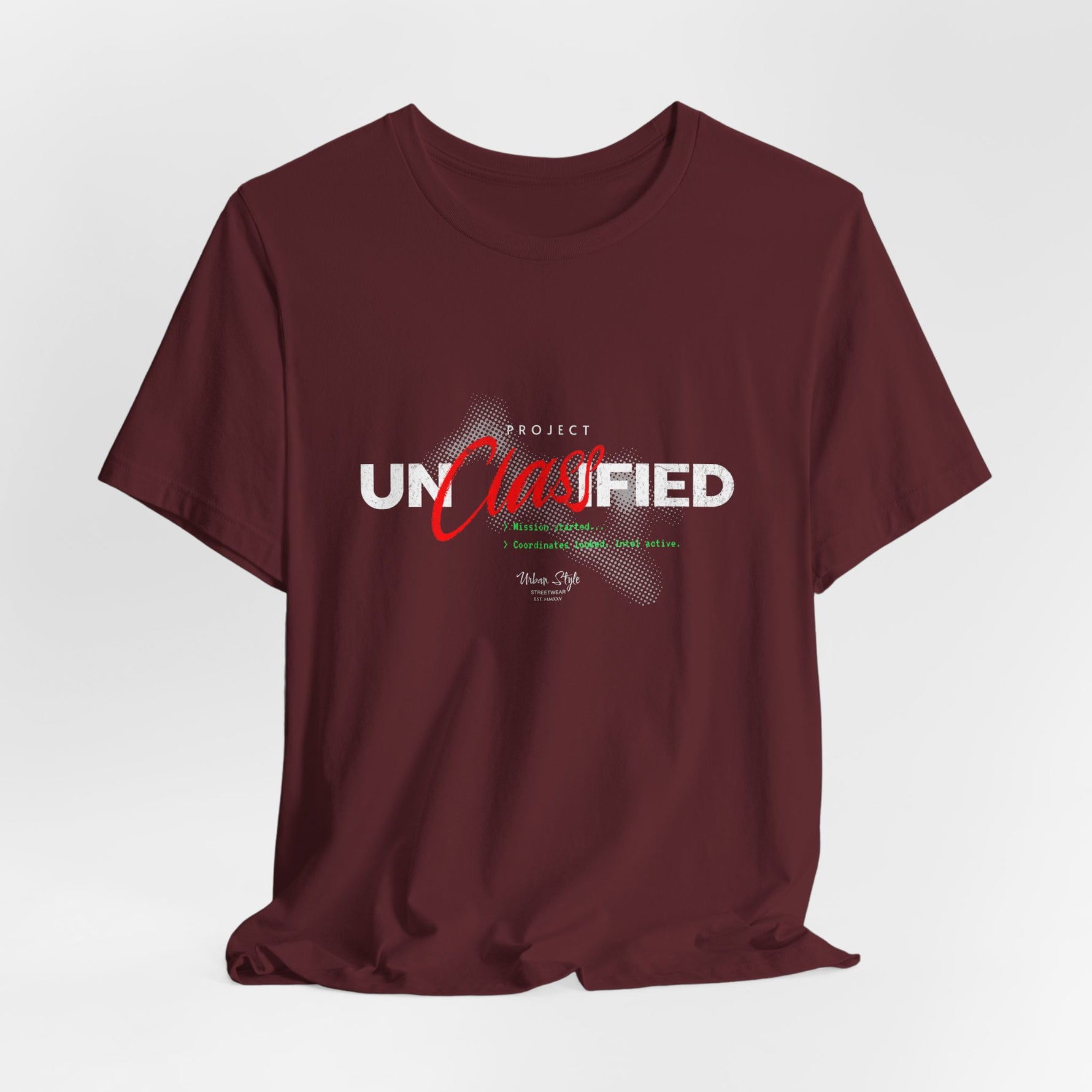 The PROJECT UNCLASSIFIED t-shirt in maroon — 3D mockup of shirt in deep maroon red, no background, no model.