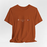 The BANGKOK t-shirt in Autumn — a deep burnt orange that evokes tropical sunsets and temple roofs.
