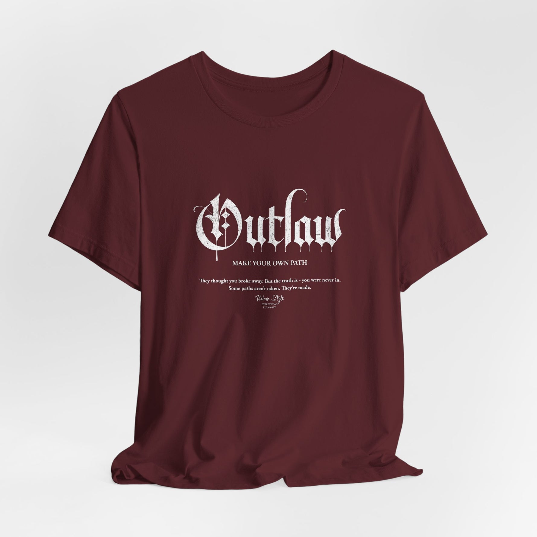 The OUTLAW t-shirt in Maroon — slow-burn strength that never asked permission.