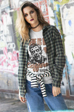 “Where Is My Coffee?” white tee by KRASSWERK – worn by female model in street-style setting with grunge backdrop, zombie graphic and casual layering