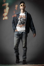“Where Is My Coffee?” white t-shirt by KRASSWERK – worn by male model in full-body urban outfit with denim layers and orange sunglasses, featuring zombie artwork