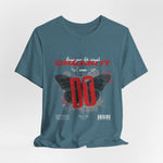 The DREAM IT DO IT t-shirt in Heather Deep Teal — moody teal base, giving depth to the red and white contrast.