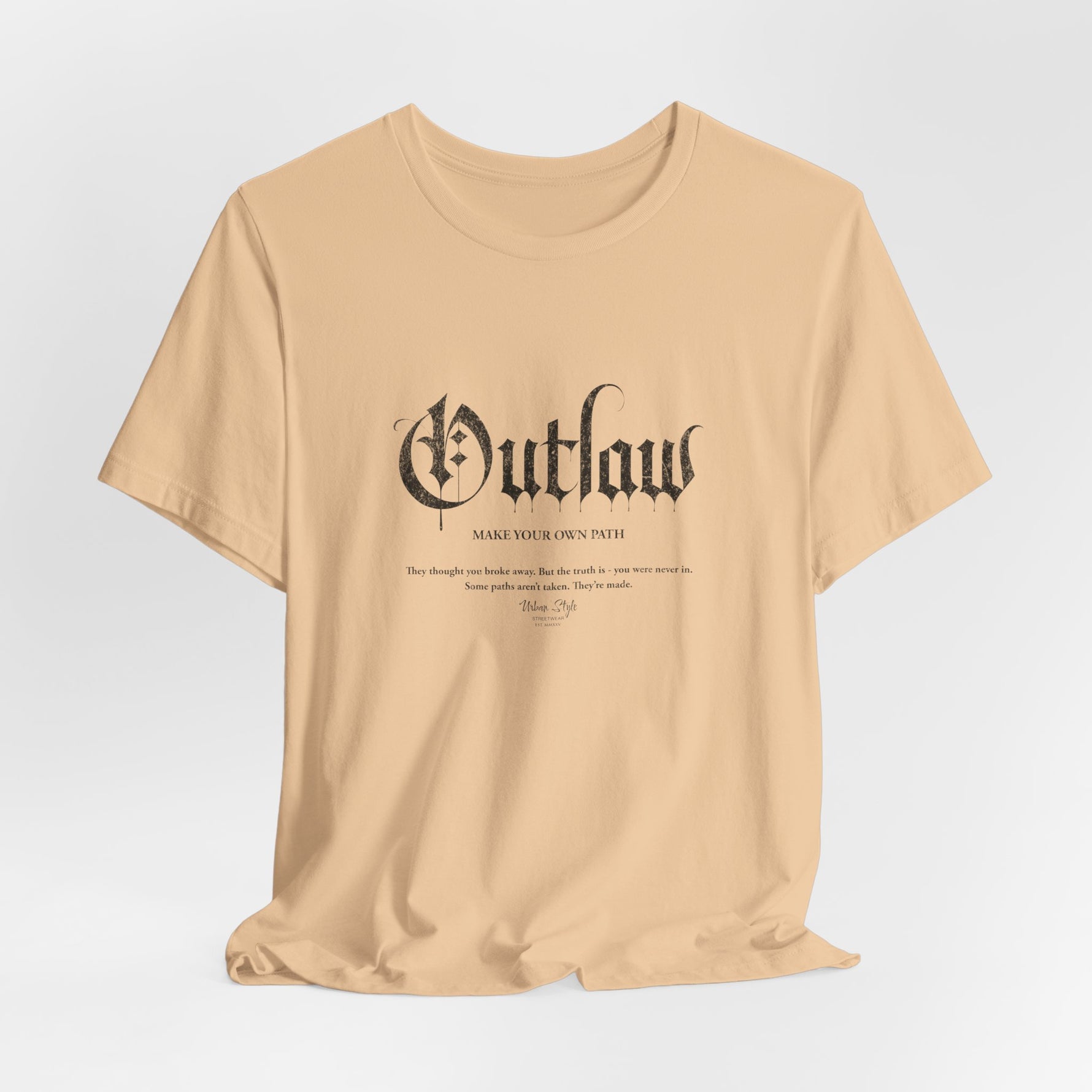 The OUTLAW t-shirt in Sand Dune — desert path energy — silence, heat, and distance.