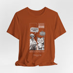 The SITONLAPTOPS t-shirt in Autumn — 3D mockup on a warm burnt-orange shirt, no model, no background. Comic artwork pops with contrast.