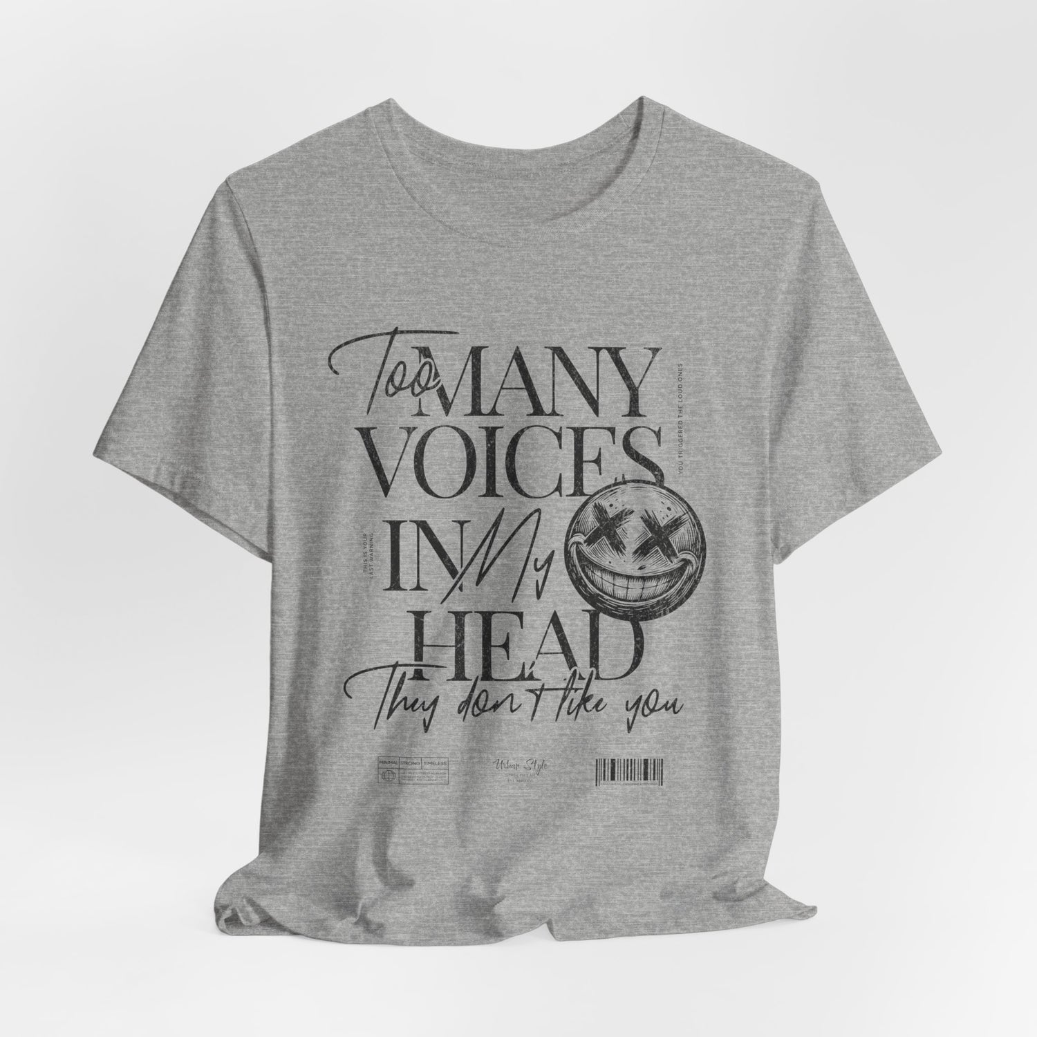 The MANY VOICES t-shirt in Athletic Heather — Blunt and buzzing — like static in your head.