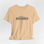 The IDENTITY OBSCURED t-shirt in Sand Dune — 3D mockup of a soft beige shirt. No background. No model.