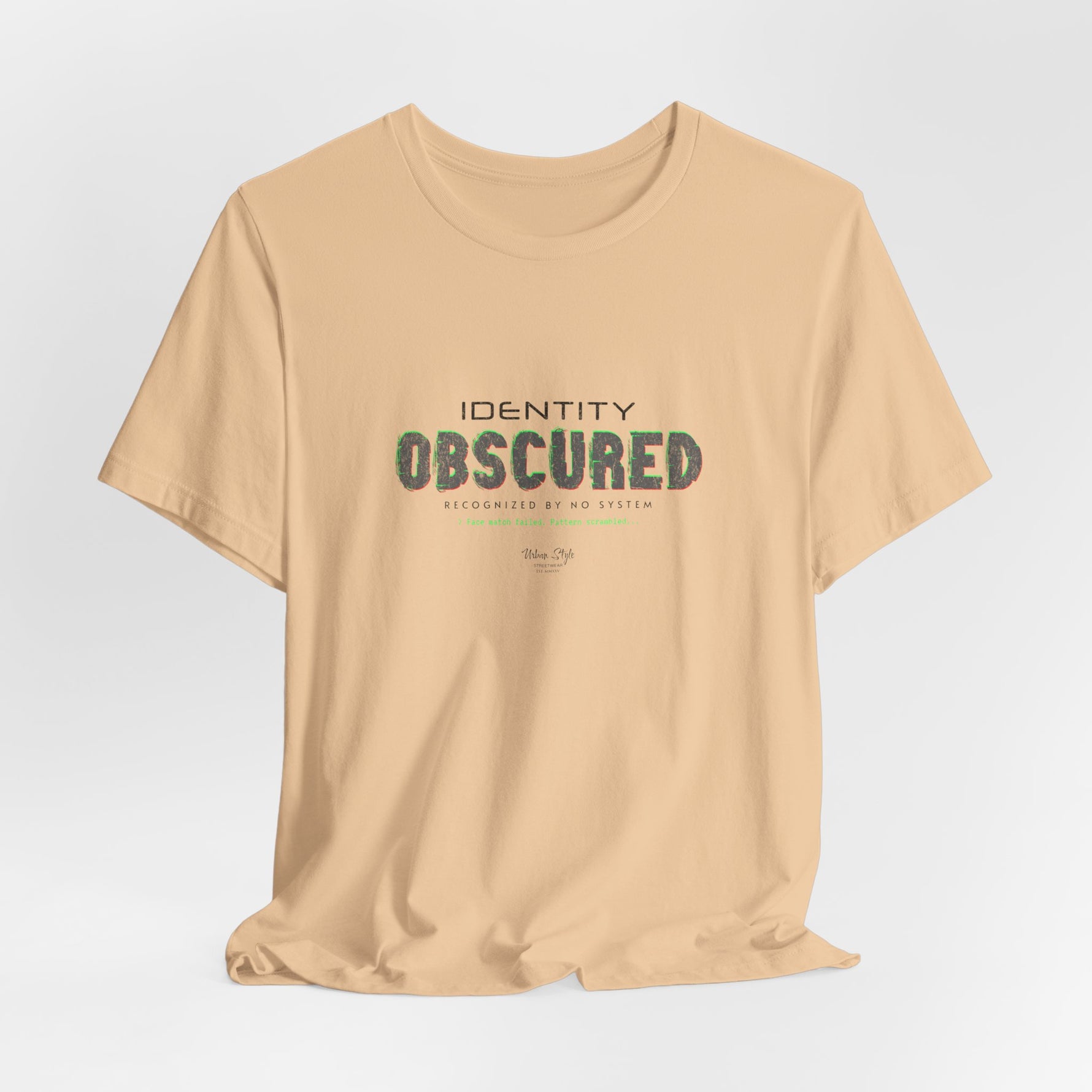 The IDENTITY OBSCURED t-shirt in Sand Dune — 3D mockup of a soft beige shirt. No background. No model.