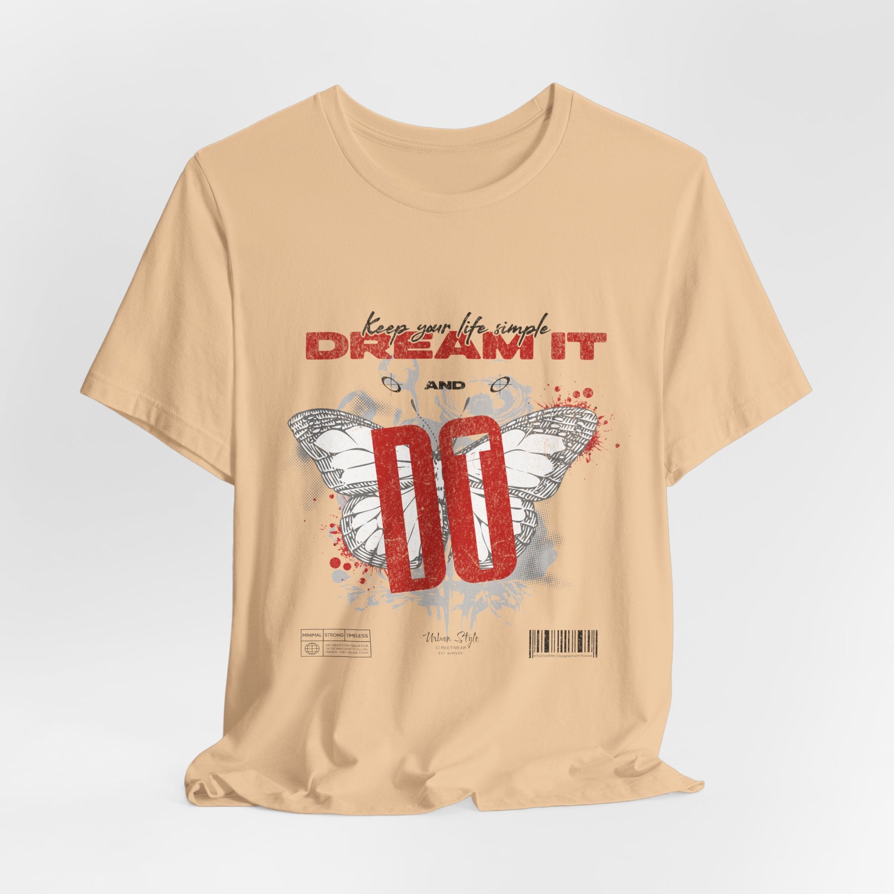 The DREAM IT DO IT t-shirt in Sand Dune — neutral tan shade that tones down the graphic into subtle coolness.