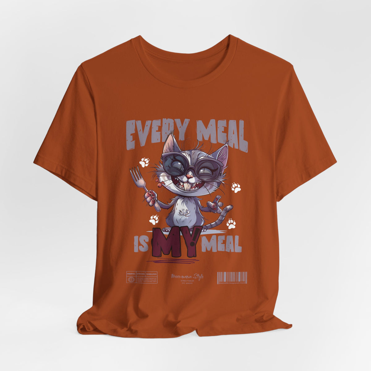 The EVERY MEAL IS MY MEAL t-shirt in autumn — warm earth tones amplify the mischievous vibe of the design.