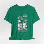 The TO RULE t-shirt in Kelly — vibrant green backdrop against black-and-white comic panels.
