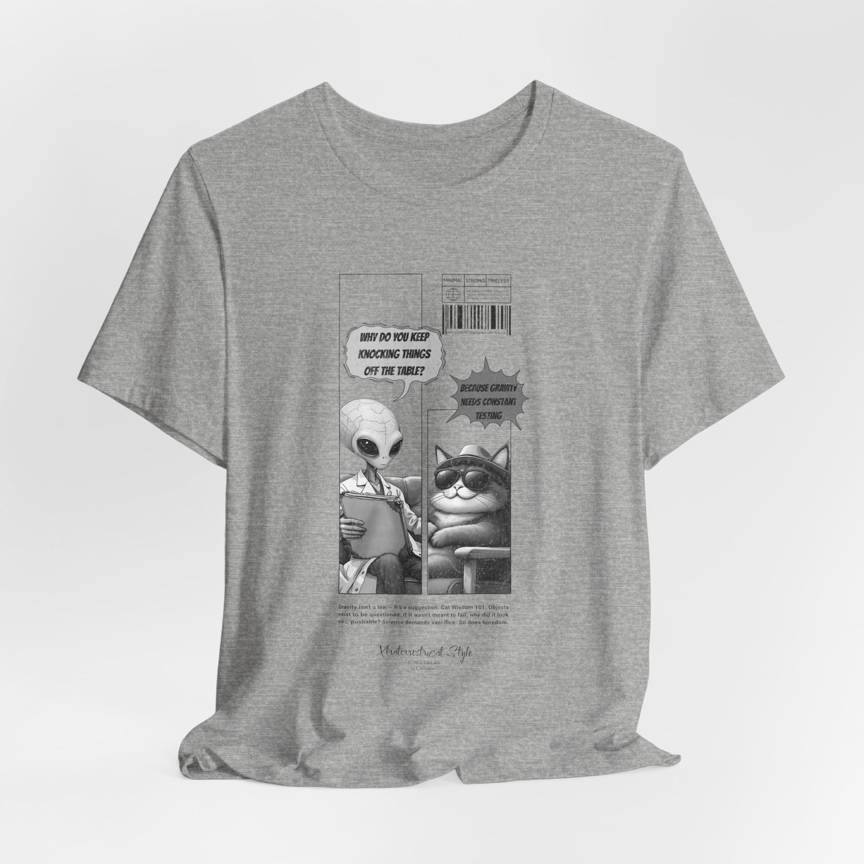 The GRAVITY t-shirt in Athletic Heather — 3D mockup in light heather grey with dark comic artwork. No additional objects or models shown.