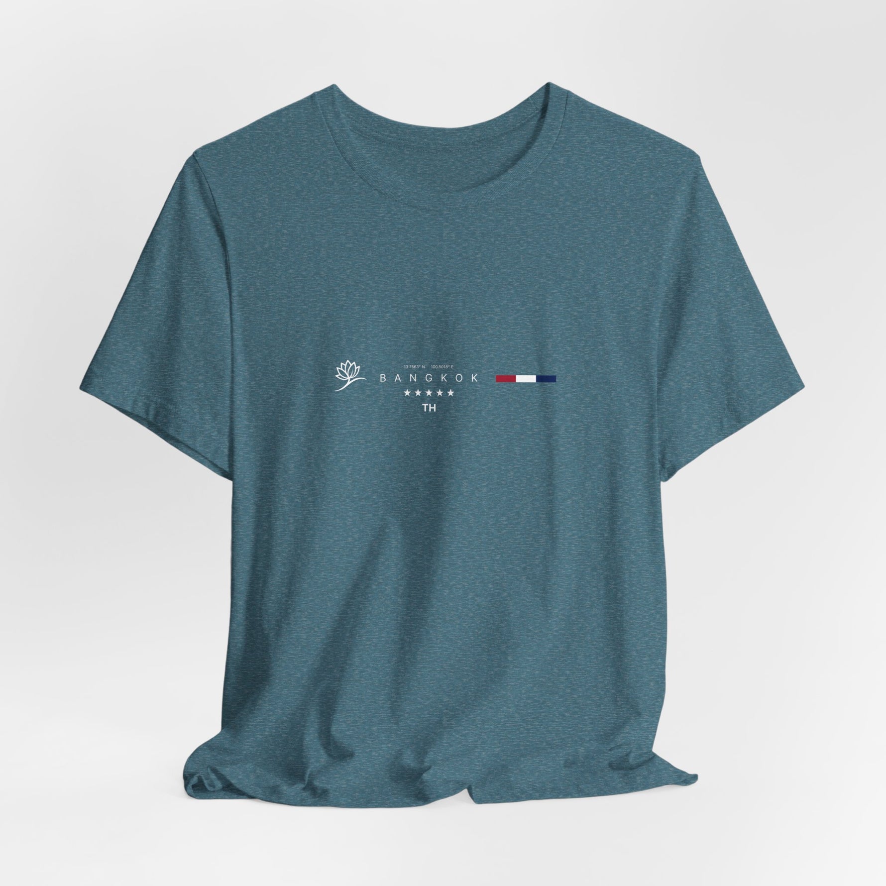 The BANGKOK t-shirt in Heather Deep Teal — a moody teal reflecting rivers and tropical storm skies.