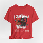The I Just Tested It t-shirt in heather red — a slightly faded red that adds playful intensity to the broken vase scene.
