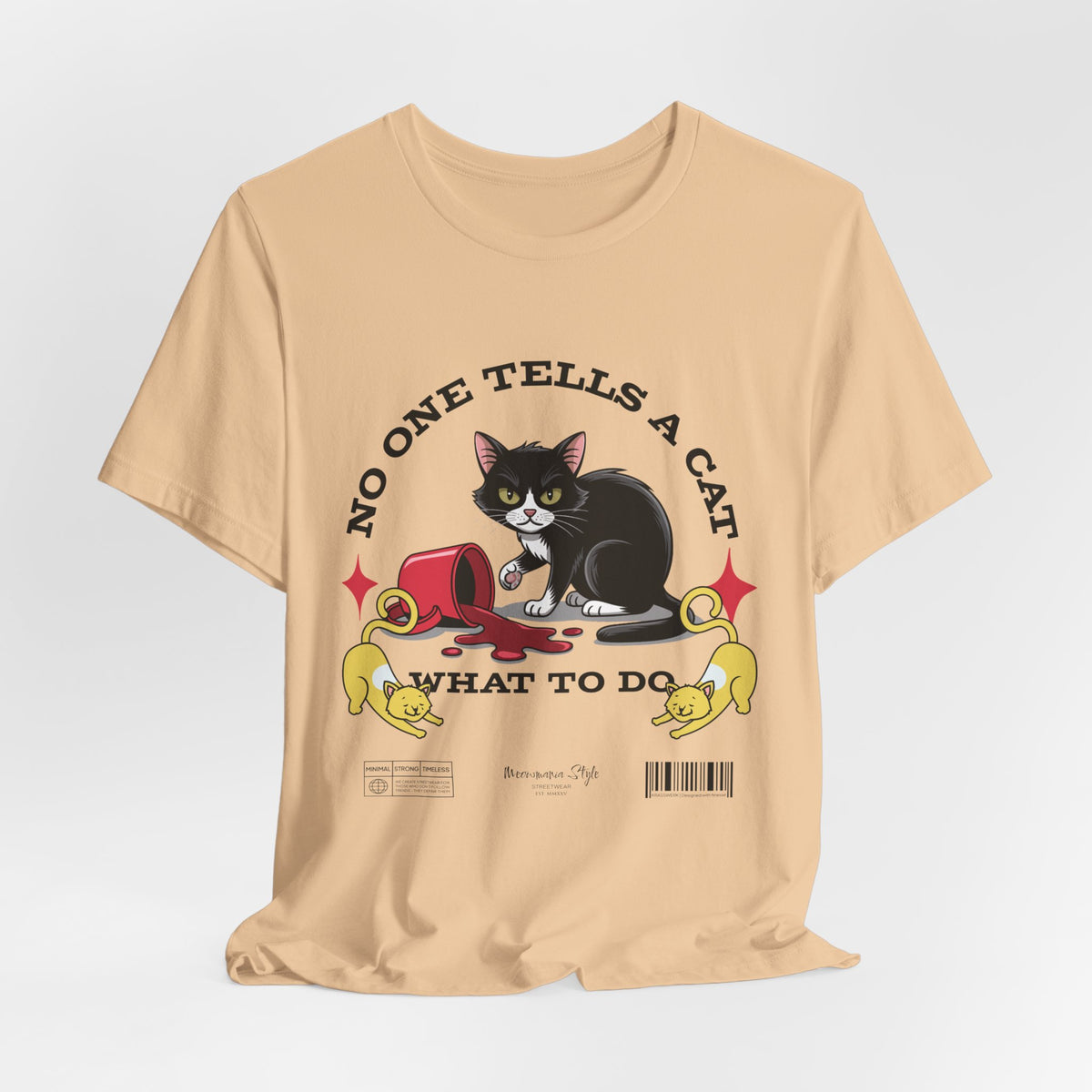 The No One Tells a Cat t-shirt in sanddune — ghost mockup showing a pale beige tone with no background or model.