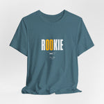 The ROOKIE t-shirt in Heather Deep Teal — quietly watching, taking mental notes.