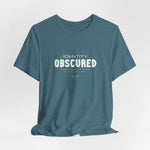The IDENTITY OBSCURED t-shirt in Heather Deep Teal — 3D mockup of a rich teal shirt. No background. No model.