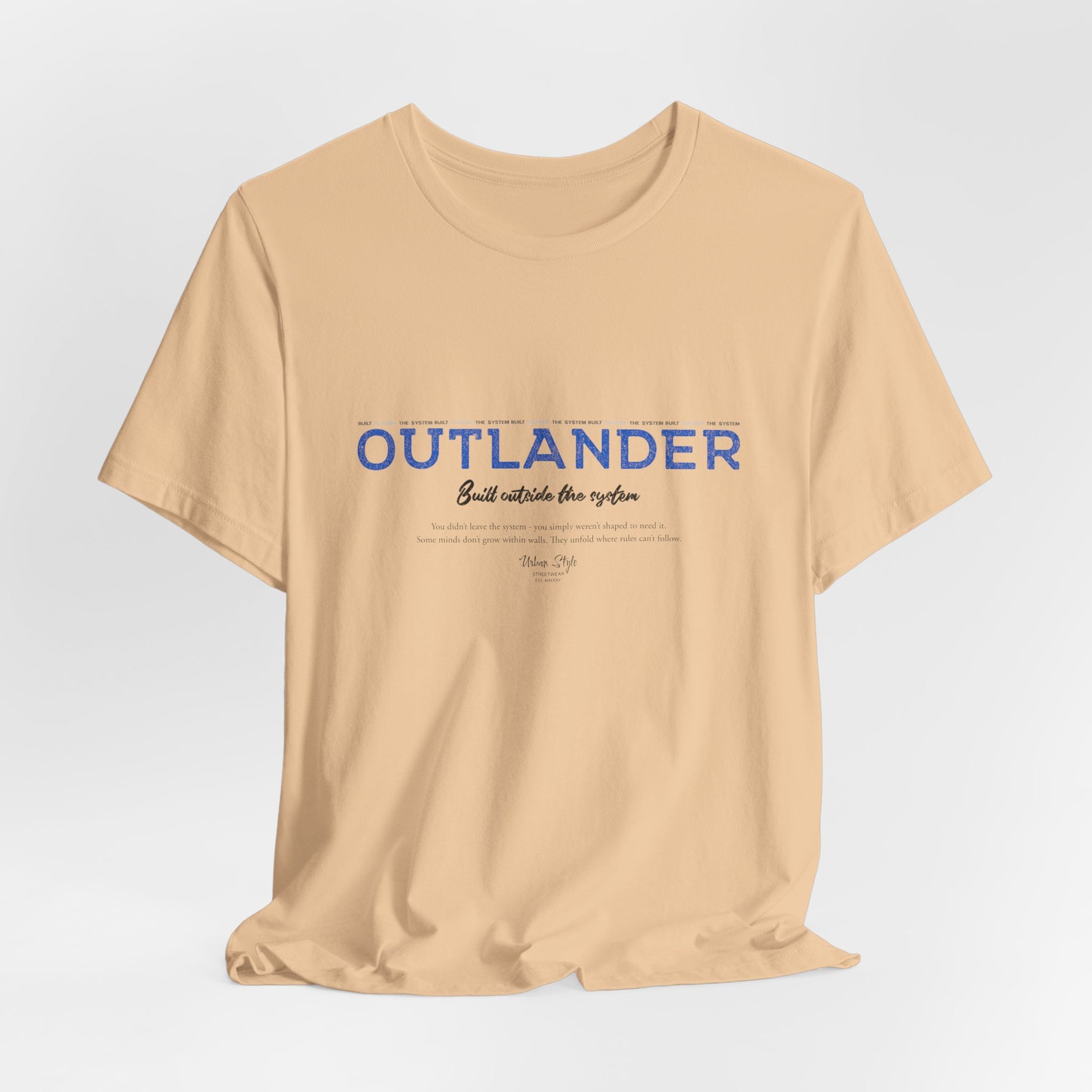 The OUTLANDER t-shirt in Sand Dune — neutral tones for those who walk unseen.