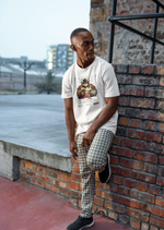 Urban outdoor scene — man leans against a brick wall wearing the TAURUS T-shirt in white. The shirt features a muscular bull in a police lineup, arms crossed, exuding quiet intensity. Text below reads “CRIME: Overprotective. Push him, regret it.” A bold visual for the unshakable types.