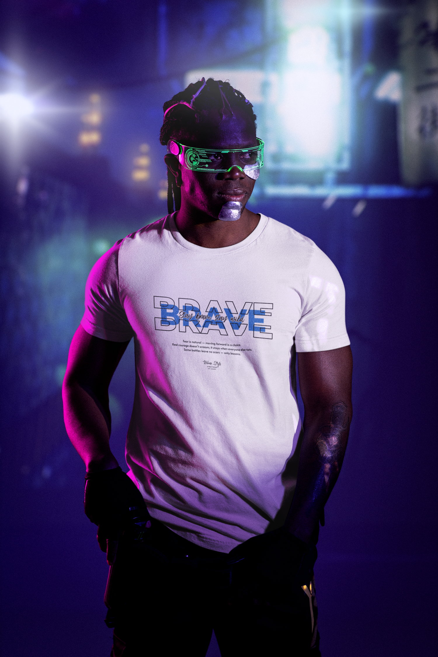 In a neon-lit world of distractions, the shirt stands out with layered “BRAVE” typography and the line “Stay brave. Stay wild.” in electric script. Cool blue gradients echo resilience. A design for those who don’t wait for safety — they move forward anyway.