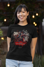 A smiling woman wearing the CHŪGI t-shirt from the 7 Virtues of Bushido series. The shirt features a fierce samurai with red and white ink splashes and the phrase "Loyalty is silent, but unbreakable." Soft outdoor lights glow in the background.