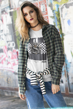 Woman in a plaid shirt and jeans standing in front of graffiti walls, wearing a white tee featuring a cat on a throne with the bold message “I DON’T RULE. I COMMAND.” Graphic has a checkered backdrop and barcode styling.