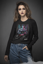 A woman with fierce eye makeup and a calm yet mysterious expression models the Gemini black t-shirt. The shirt’s artwork shows a tattooed character with two contrasting sides — one vibrant and smiling, the other pale and somber, symbolizing the internal conflict behind a charming face.
