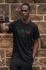 A serious-looking man in a black t-shirt stands against a rugged stone wall, holding his phone up for a selfie. The shirt reads “OPERATION GHOSTLINE” with a green radar and glitch-style red/green text, evoking a secret mission vibe. The earthy texture of the wall complements the stealthy tone of the design.
