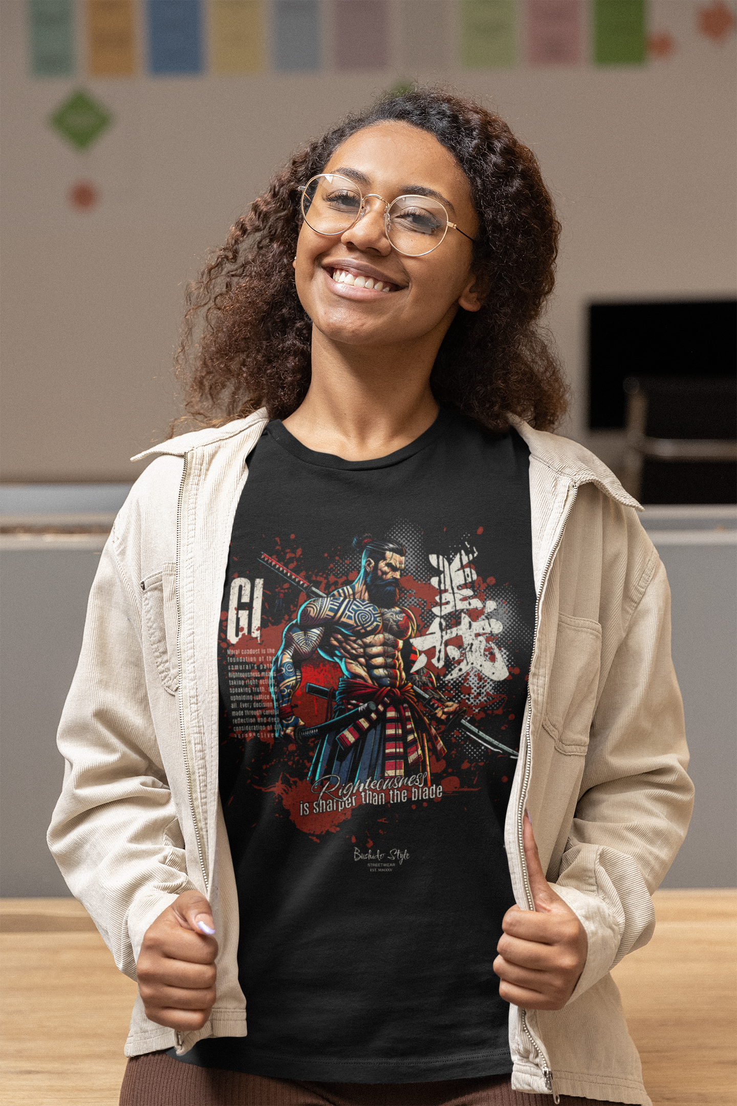 A confident young woman opens her beige jacket to reveal the GI t-shirt. The warrior design bursts with vivid colors and the virtue of righteousness.