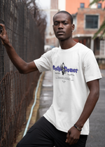 Male model in an urban alleyway, leaning on a fence while wearing the "Gothic Power" t-shirt in white. The purple gothic text and dark skull design contrast the clean fabric, evoking a modern, gritty aesthetic.