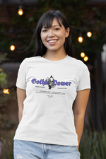 Smiling female model in a casual outdoor setting wearing the "Gothic Power" t-shirt in white. The bold purple gothic lettering and skull emblem stand out, blending mystery with modern streetwear.
