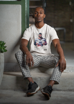 Man sitting on indoor stairs wearing the LIBRA t-shirt in white. Urban casual setting with soft lighting. Design shows a tattooed man holding two documents labeled LIBRA, with crime: Decision Delay.