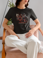 “REI” black t-shirt by KRASSWERK – lifestyle photo of woman seated in soft-lit interior, wearing Bushido-inspired respect-themed graphic tee with red and black samurai design