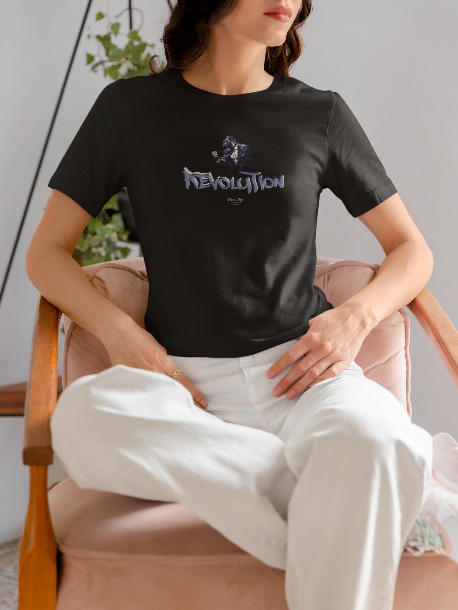 REVOLUTION black tee by KRASSWERK – worn by female model in soft interior setting, relaxed pose highlighting minimal streetwear tone