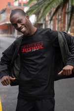 Confident model smiling wide in a city street, pulling open his jacket to reveal the black SAVAGE t-shirt with bold red text and the phrase “Wired Different.” Urban, raw energy.