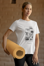 A woman stands confidently in a warm-toned studio, holding a rolled yoga mat in one hand. She wears a white t-shirt printed with a black-and-white comic design. The comic shows an alien asking, “Why do you sit on laptops?” and a smug-looking cat replying, “Because you hate it. And it's warm.” The overall vibe is modern and humorous, blending everyday fitness style with nerdy cat attitude.