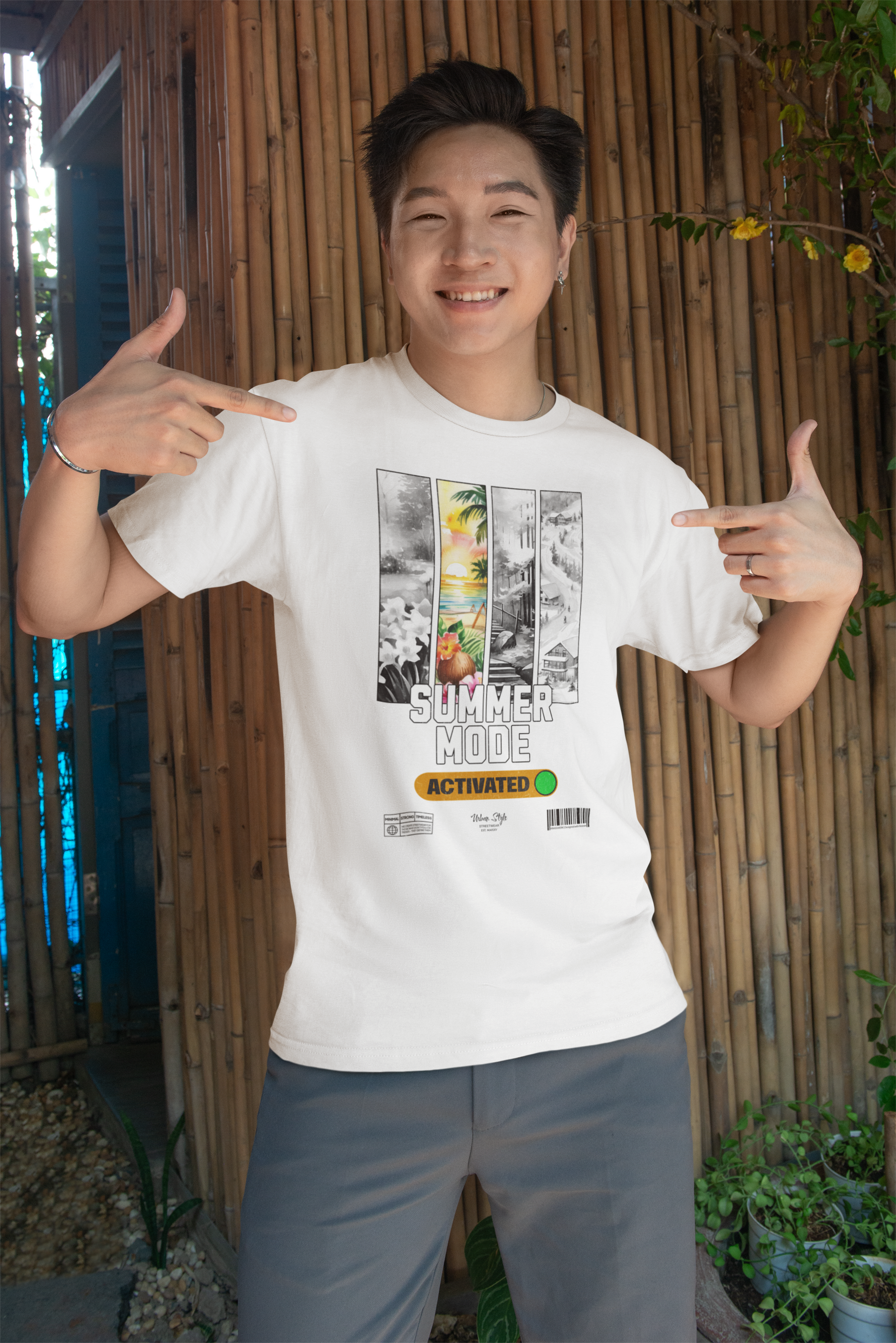 Smiling man pointing at his white “SUMMER MODE Activated” t-shirt — vibrant tropical panel art pops against clean summer tones.