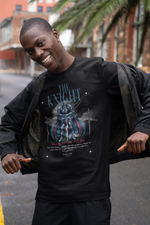 A confident man smiling in an urban setting, opening his jacket to reveal THE KNIGHT t-shirt design featuring a blue-armored warrior and the slogan “Valor Never Yields”.