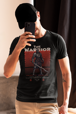 Man in a black cap takes a mirror selfie while wearing THE WARRIOR t-shirt — showcasing the armored knight graphic and bold 'Born to Conquer' message in a warm, natural-lit setting.
