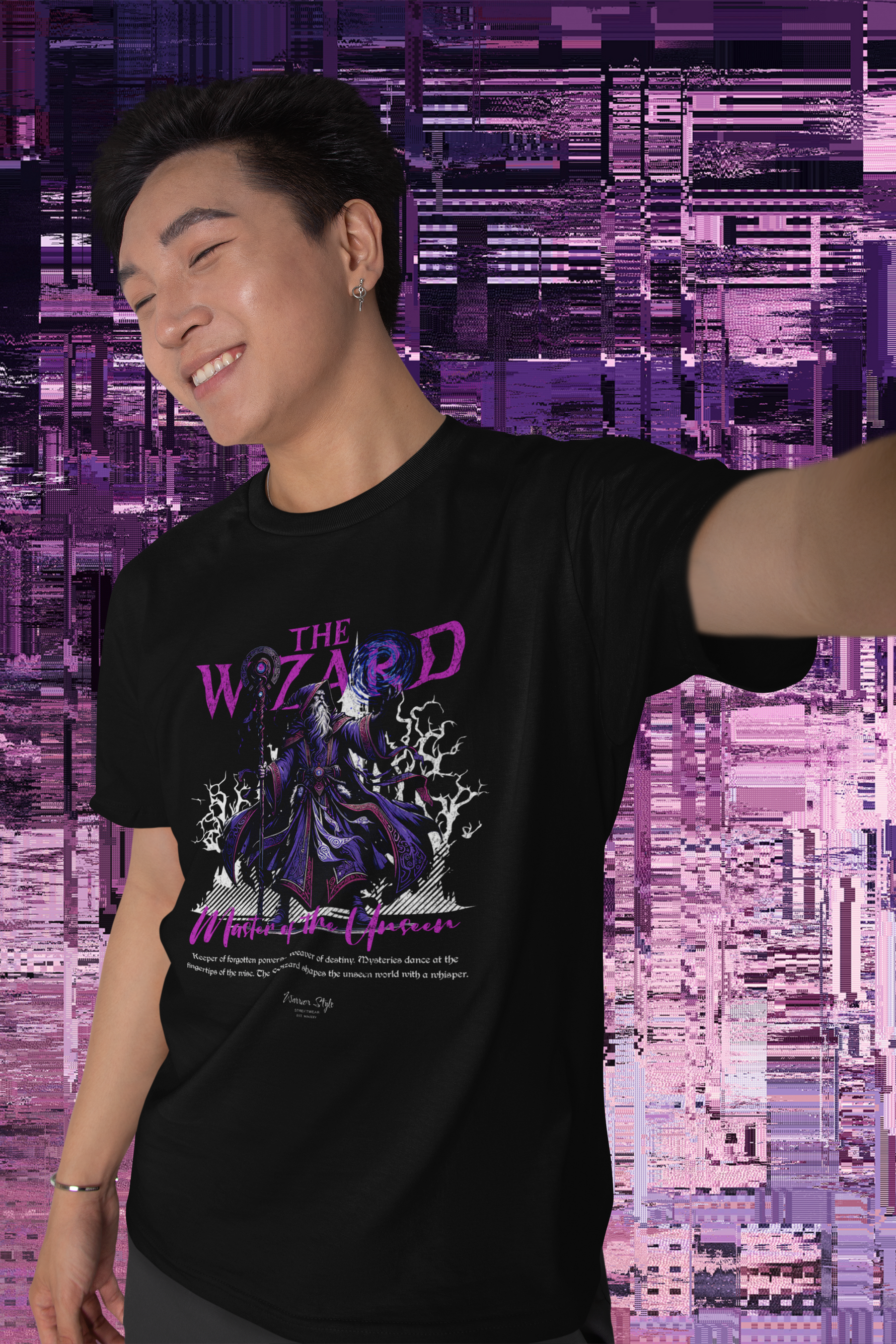 Smiling man in a digital art–style environment wears THE WIZARD t-shirt. The design glows with mystical purple energy, featuring a cloaked sorcerer conjuring lightning.